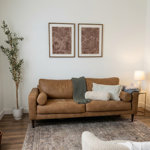 A welcoming two-person couch in a calm couples counseling space